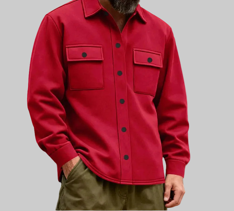 Person wearing a red jacket with the Statue of Liberty in the background