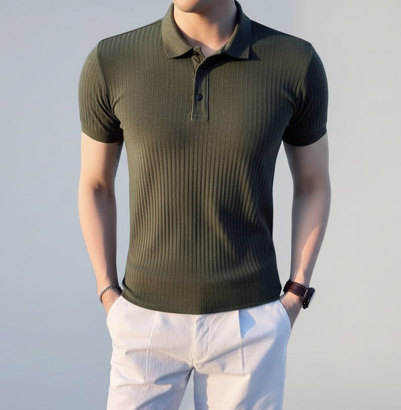 Person wearing a green polo shirt by a waterfront with a boat in the background