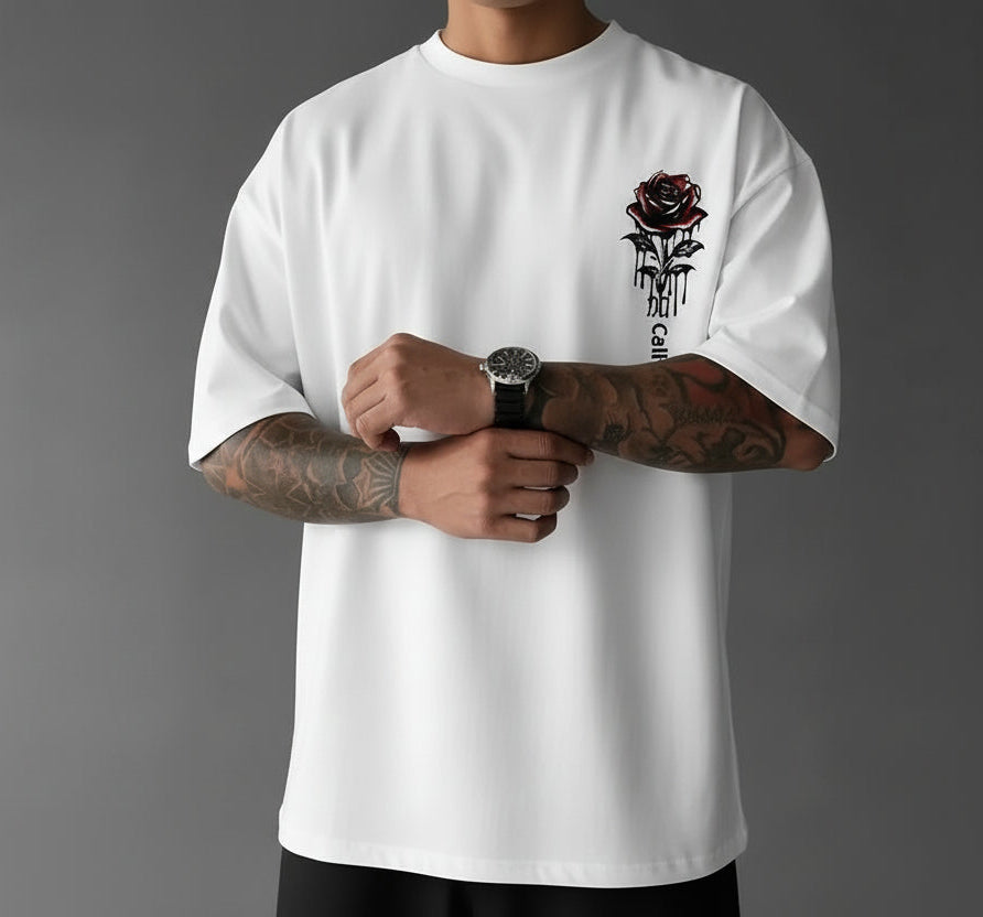 Person wearing a white t-shirt with a rose design and 'California' text on a gray background